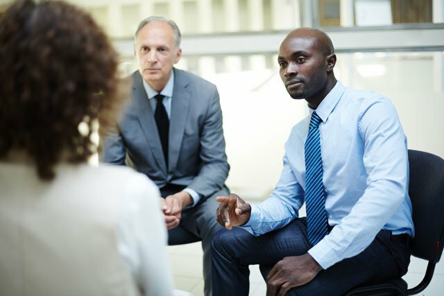 business owner and a security officer discussing ending a strike